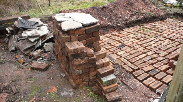 One layer of bricks down, the gaps get filled with concrete and another layer on top.