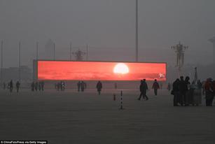 A giant screen to show Tiananmen square what the sunrise looks like from above the smog.